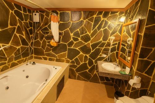 a bathroom with a tub and a sink at Tiger Complex Inn in Patong Beach