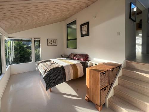 a bedroom with a bed and a table and a window at Medlands Retreat with Breathtaking Views in Medlands