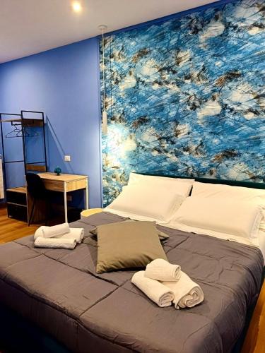 a bedroom with a large painting on the wall at Marilù Accoglienza del Sud in Foggia
