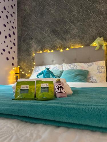 a bedroom with a bed with two towels and a teddy bear at Suíte Monstros SA - Pousada Castelo do Luar in Penha