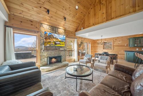 a living room with a couch and a fireplace at Sugar View Chalet in Banner Elk