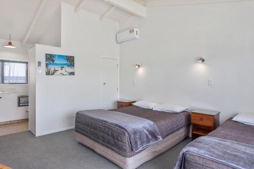 Ένα ή περισσότερα κρεβάτια σε δωμάτιο στο NauMai Motel