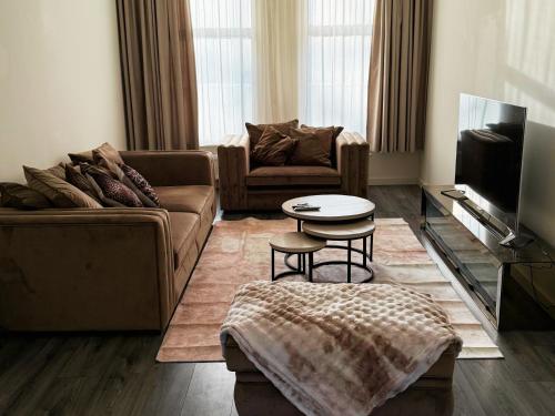 a living room with a couch and a table at Woonhuis 170m2 Rotterdam Centrum in Rotterdam