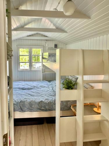 a small bedroom with a bed and a window at 180 Degree View Over Sebbersund Fjord in Nibe
