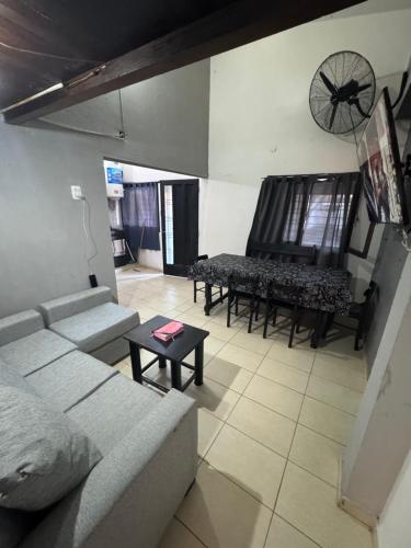 a living room with a couch and a piano at Casa Familia Mateo in Santa Teresita