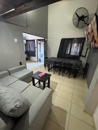 a living room with a couch and a piano at Casa Familia Mateo in Santa Teresita