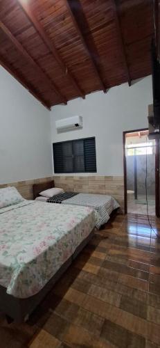 a bedroom with two beds and a television in it at Casa de Bonito in Bonito