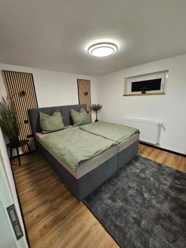 a bedroom with a bed and a couch in it at harmonische 2-Zimmer Ferienwohnung in Nörten-Hardenberg