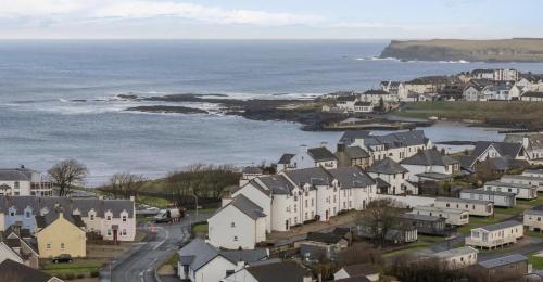 an aerial view of a town next to the ocean at Coastal View in Bushmills