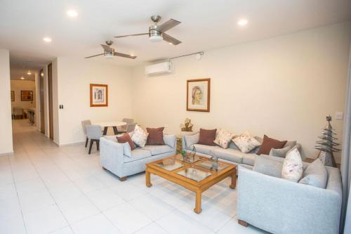 a living room with two couches and a coffee table at Casa Itzae Hotel Boutique in Mérida