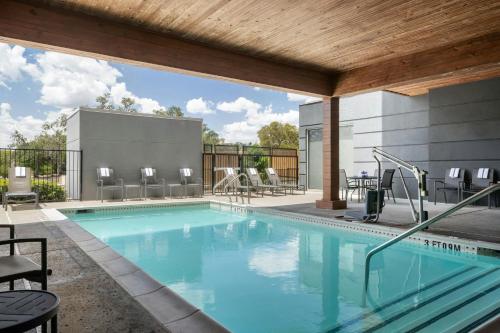 a large swimming pool with chairs and tables at Fairfield by Marriott Inn & Suites San Antonio Medical Center in San Antonio