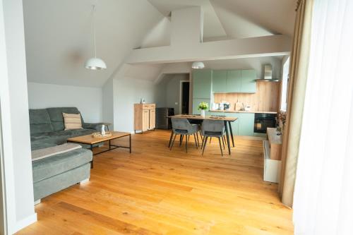 a living room with a couch and a table at The Nest Beneath the Citadel - 5 min to City Square in Râşnov