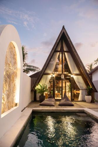 an exterior view of a house with a swimming pool at Private villa 1 bedrooms Kaba-kaba tabanan in Kapal