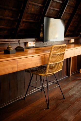 a wooden desk with a chair in front of it at Private villa 1 bedrooms Kaba-kaba tabanan in Kapal