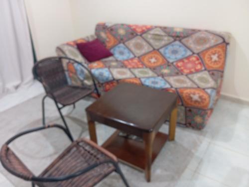 a living room with a couch and two chairs at Happy living room stay in Sharjah