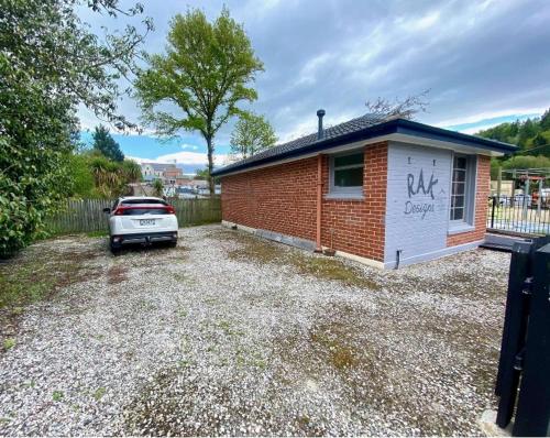 a car parked in front of a small house at The Batch in Lawrence