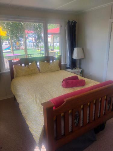 a bedroom with a large bed with a large window at The Batch in Lawrence