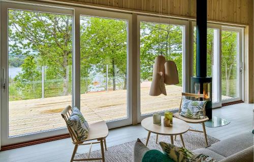 a living room with a large sliding glass door at Cozy Home In Myggenäs With Sauna in Höviksnäs