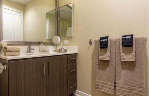 a bathroom with a sink and a mirror and towels at Marina Retreat, Near Beaches&SoFI in Los Angeles