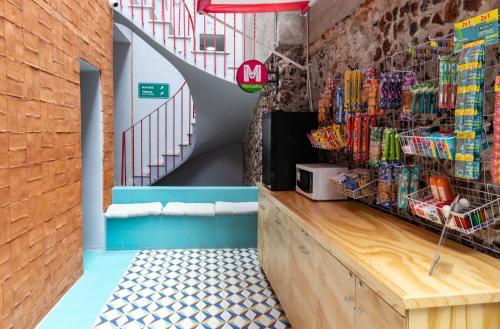a fast food restaurant with a counter and stairs at Hostal CASA MX bellas artes in Mexico City
