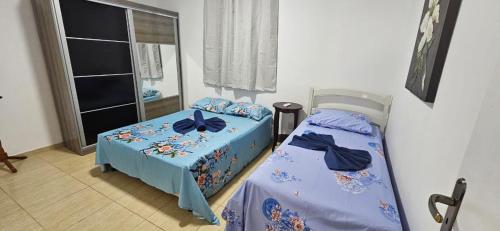 a bedroom with two beds and a window at Casa Harmonia in Aracaju