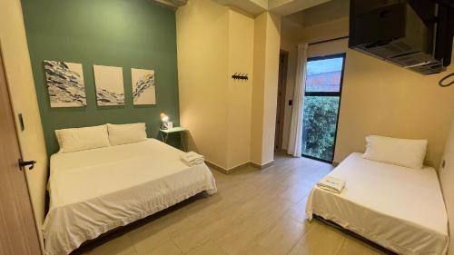 Postel nebo postele na pokoji v ubytování Awa House Hotel