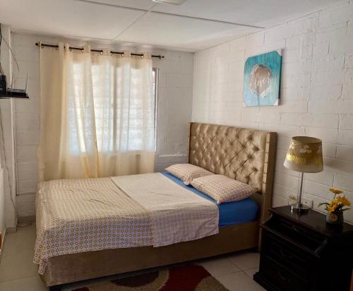 a bedroom with a bed and a window at Casa campestre Magyli in Puerto Salgar