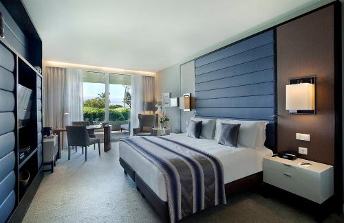 a hotel room with a large bed and a desk at InterContinental Cascais-Estoril by IHG in Estoril