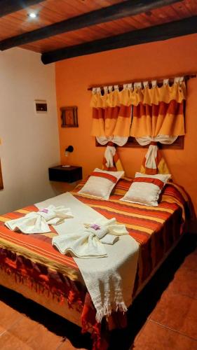 a bedroom with a bed with towels on it at Cabañas La Soñada in Chajarí