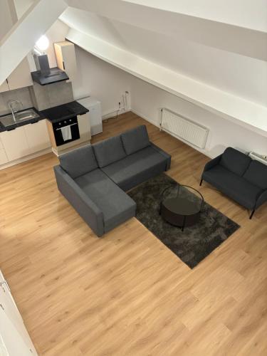 a living room with a couch and a table at Cosy Appartement 1 Chambre et Sofa bed in Brussels