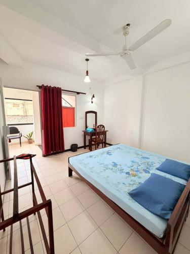 a bedroom with a large bed in a room at Athula Beach Front Hotel Hikkaduwa in Hikkaduwa