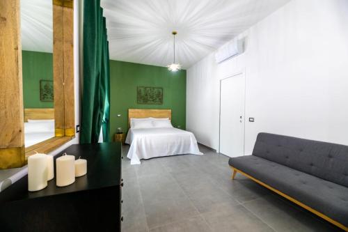 a bedroom with a bed and a couch at Mira Vietri in Vietri sul Mare