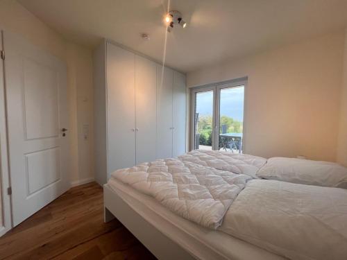 Ένα ή περισσότερα κρεβάτια σε δωμάτιο στο Ferienwohnung-Frees-Mooi