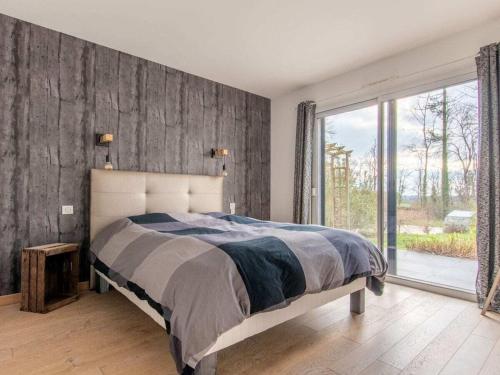 a bedroom with a large bed and a large window at DUXCAAR Mervent in Mervent