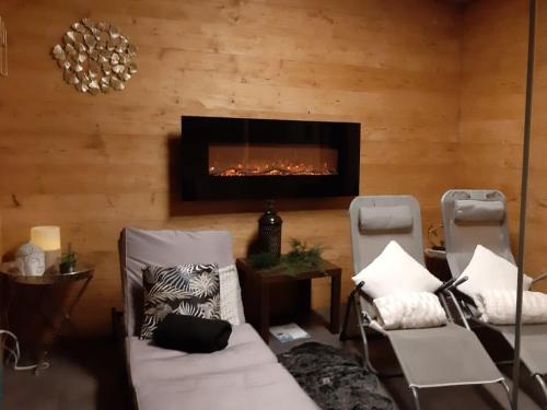 a living room with two chairs and a fireplace at Holiday apartment with 1 bedroom in Furth im Wald