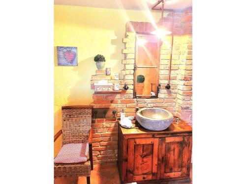 a bathroom with a sink and a stone wall at Holiday apartment with 1 bedroom in Furth im Wald