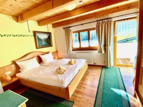 ein Schlafzimmer mit einem Bett, auf dem ein Teddybär liegt in der Unterkunft Hoher Göll in Punzenlehen in Engedey