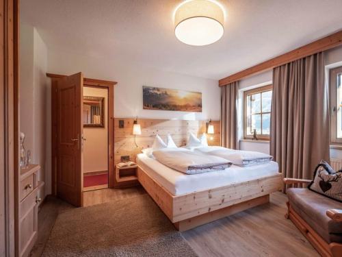 a bedroom with a large bed and a couch at Holiday apartment Tristnerblick in the Huaterhof in Laimach
