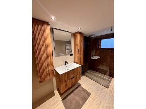 a bathroom with a sink and a mirror at Holiday home Burgblick in Kranichfeld