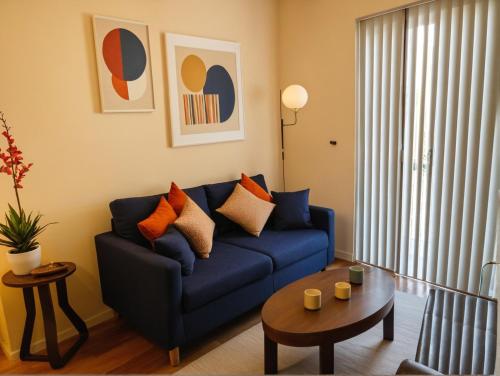 a living room with a blue couch and a table at 3 bedroom Home Casa Serenity Central Los Angeles in Los Angeles