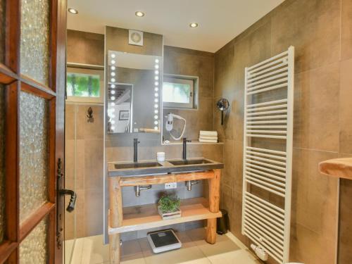 a bathroom with a sink and a mirror at Maswari en Drapeau in Lusignac