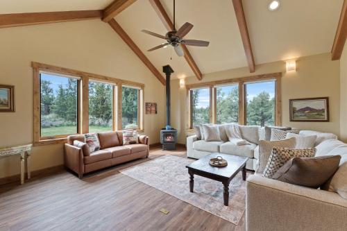 a living room with couches and a ceiling fan at High Lowe in Bend