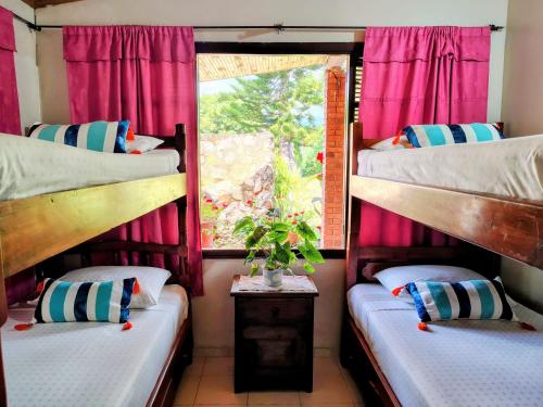 Giường trong phòng chung tại Finca El Paraíso