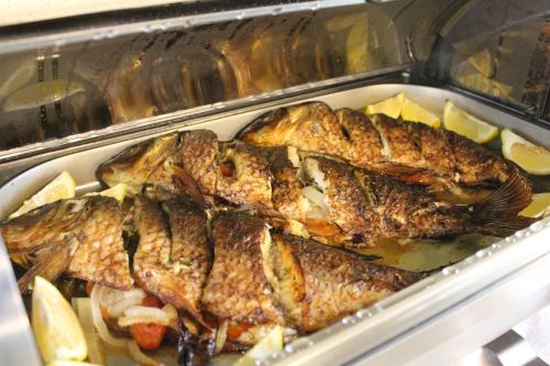 a tray of fish and vegetables in an oven at Truskavets 365 Hotel in Truskavets