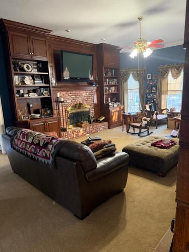 a living room with a couch and a tv at Exquisite Victorian in Springfield