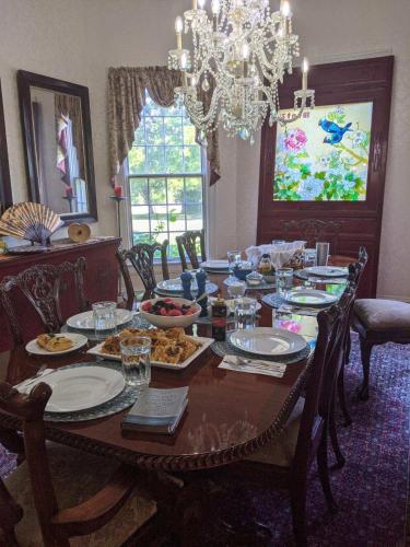 a dining room with a table with food on it at Exquisite Victorian in Springfield
