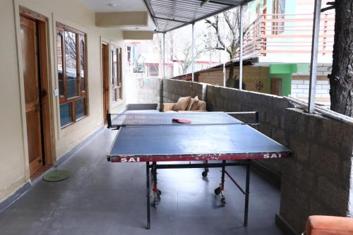 a ping pong table in the middle of a room at Blest Inn Kasol in Kasol