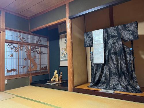 a room with a window with a dress on display at 瀬戸内庵Setouchian in Takamatsu