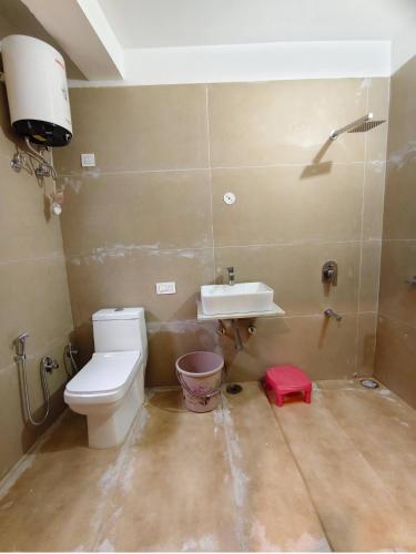 a bathroom with a toilet and a sink at Blest Inn Kasol in Kasol