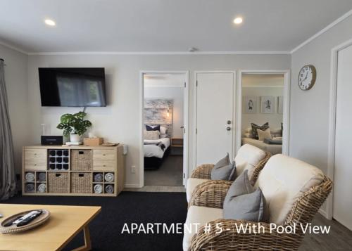 a living room with a couch and a table at Stay n Play n Russell in Russell